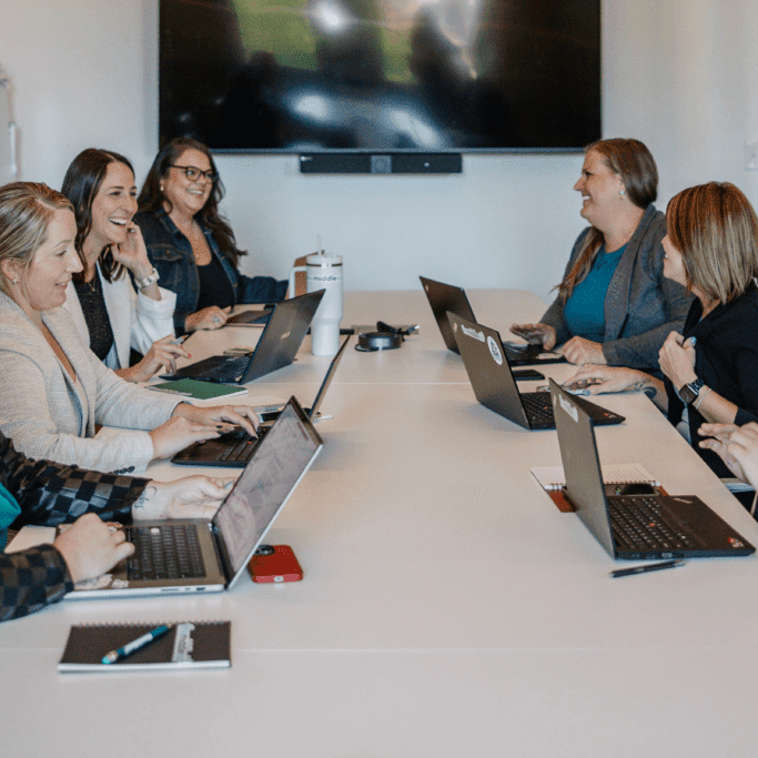 Sales team collaborating on sales enablement strategy and CRM optimization in 2025.